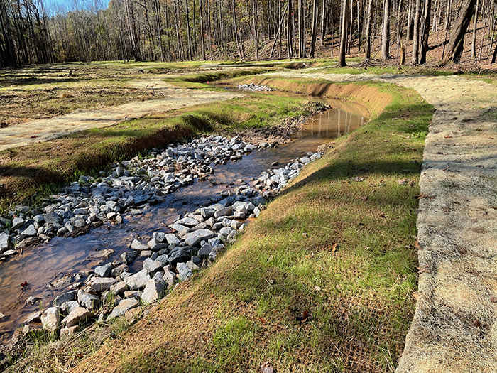 Coir mat installed near water for erosion control