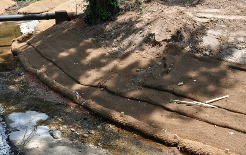 Biodegradable coir mat being installed